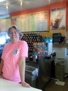 Woman smiling inside her restaurant