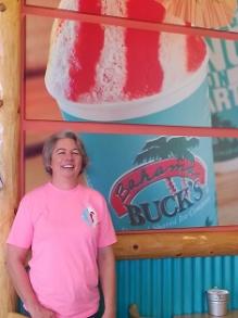 Woman smiling outside restaurant sign