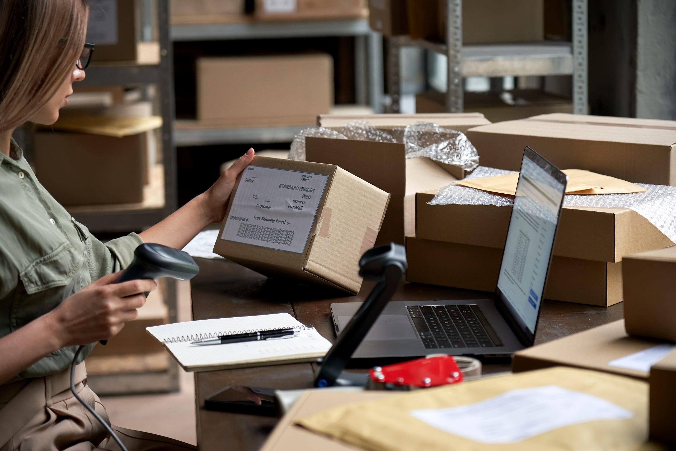 woman placing label on box